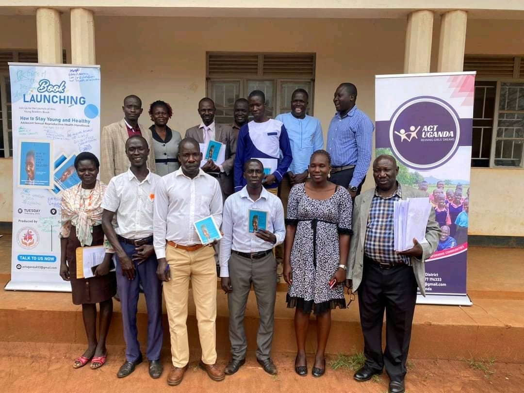 District officials and ACT Uganda staff at the launch of the 'How to Stay Young and Healthy' adolescent SRHR handbook