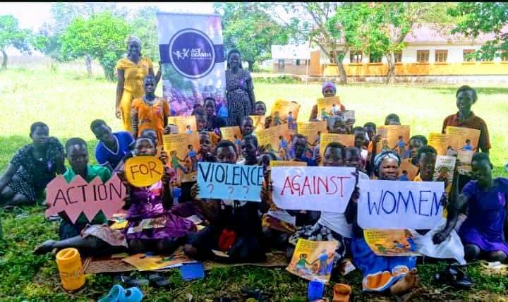 Community members holding signs promoting action against violence against women