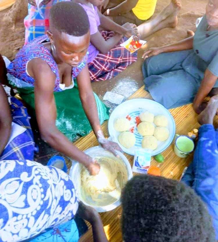 Women kneading dough during a baking and vocational skills training session