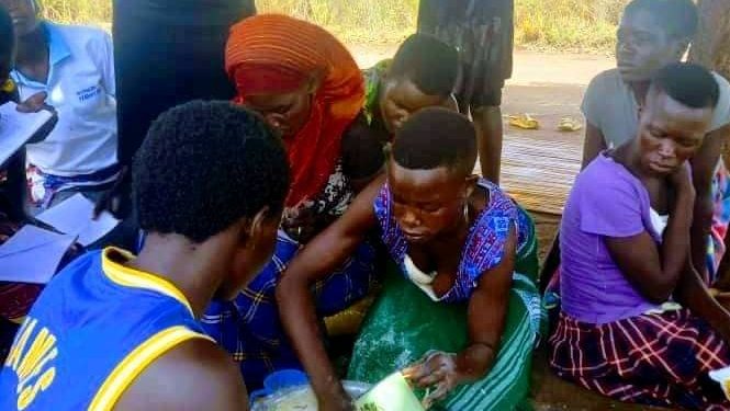 Members of a women's group preparing food together as part of an income-generating activity