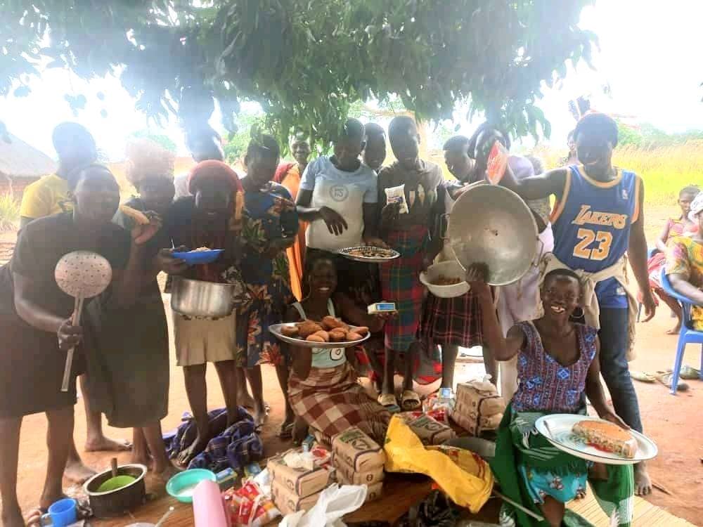 A VSLA group displaying food items and goods prepared as part of an income-generating activity